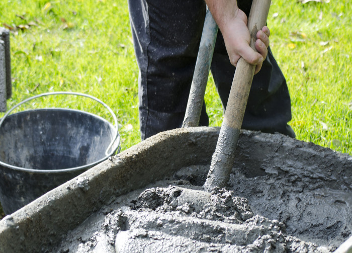 concrete in trolley with worker and shovel